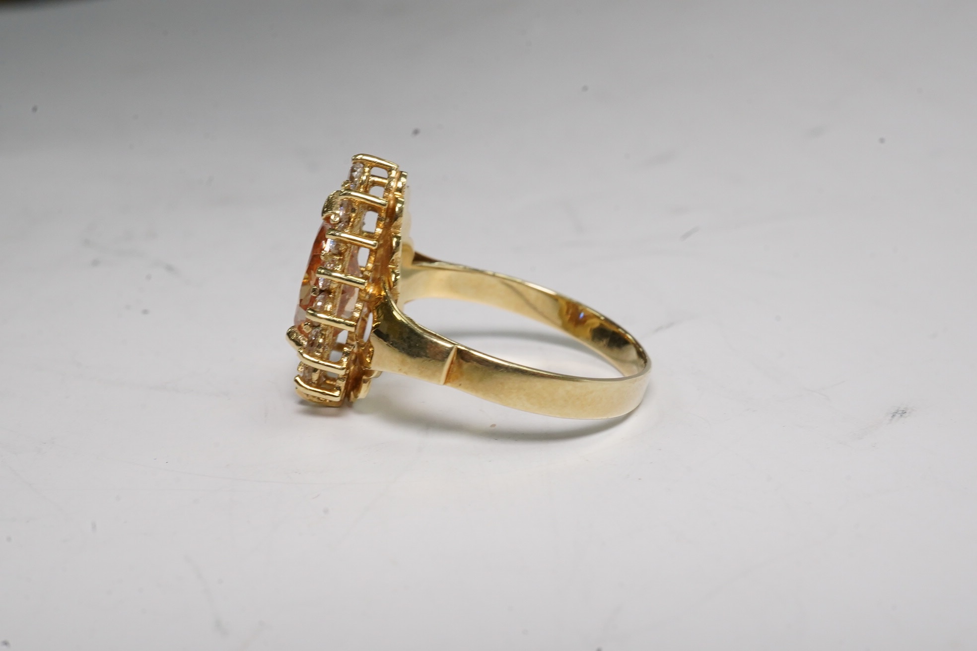 A 14k and simulated diamond set pear shaped cluster ring, size N, gross weight 3.8 grams. Condition - fair to good